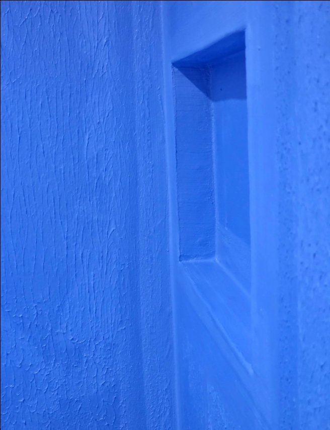 Blue waterproofing membrane inside a recessed wall shelf
